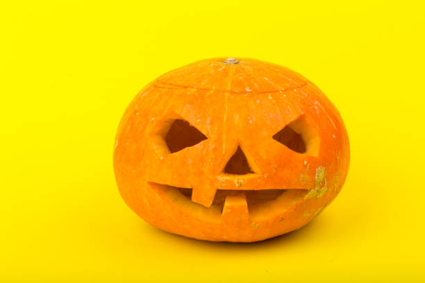 istock Halloween pumpkin head jack lantern on yellow background 1279975012