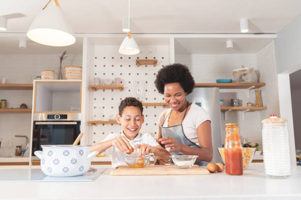 istock Mother and son cooking with eggs in kitchen 1279975925