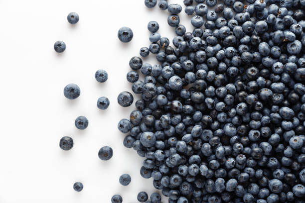 istock Blueberries scattered on a white background. View from above 1279976753