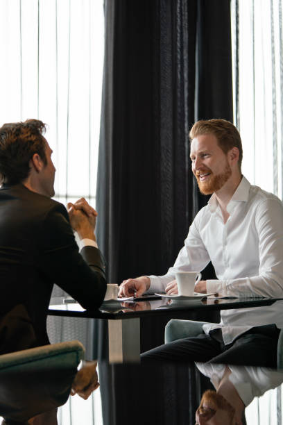 istock Handsome two businessmen have a meeting in cafe 1279977032