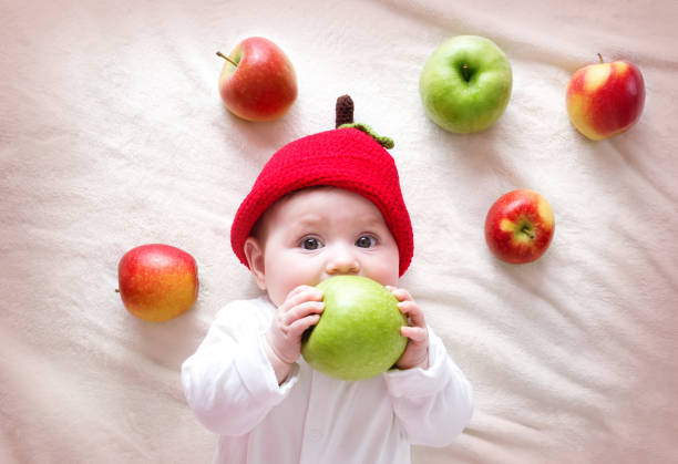 yellow red apple in front of white background