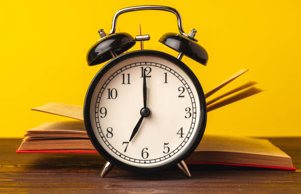 istock Books and alarm clock on table, education concept 1279977224