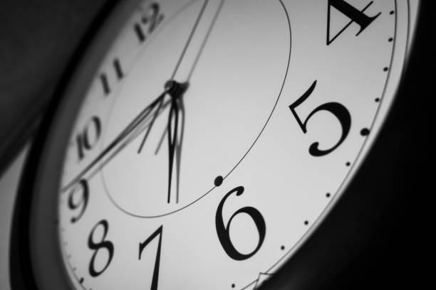 Close up of a wall clock on dark background