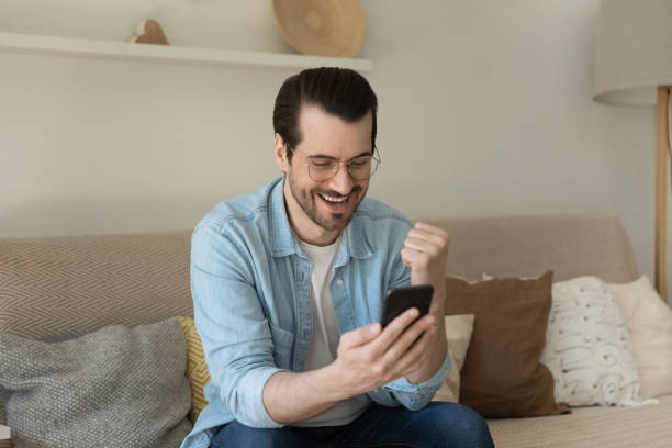 istock Young happy man reading sms with good news. 1279977872