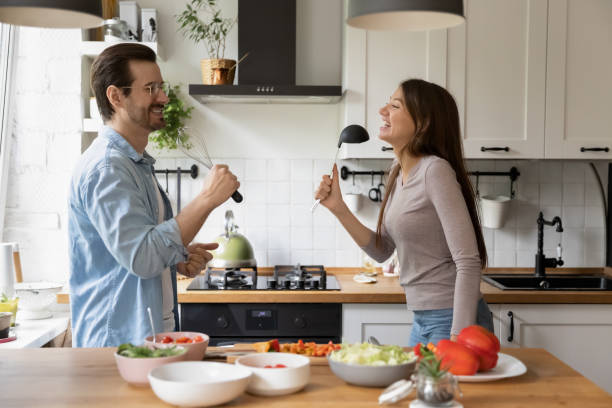 istock Playful family couple having fun in kitchen. 1279977994