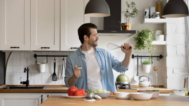 istock Happy young energetic man singing favorite song. 1279977998