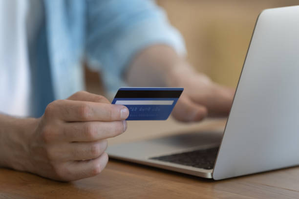 istock Close up young man holding banking card in hands. 1279978041