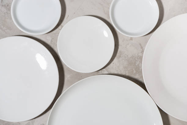 istock set of clean white plates on white background, top view 1279978393