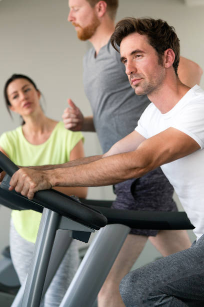 istock Group of friends exercising on treadmill machine 1279978515