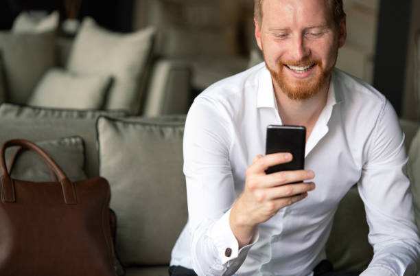 istock Successful happy businessman using mobile phone in office 1279978625
