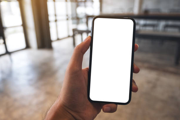 istock a man holding black mobile phone with blank white screen in cafe 1279979543