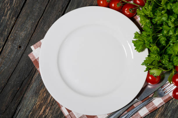 istock table setting with white plate and vegetables on wooden background, top view 1279979584