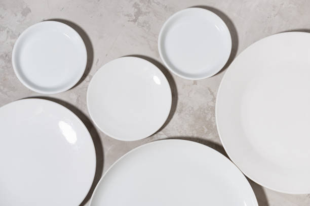 istock set of clean white plates on white background 1279979896