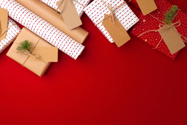 istock Christmas preparations concept with wrapping paper, gift boxes on red background 1279980400