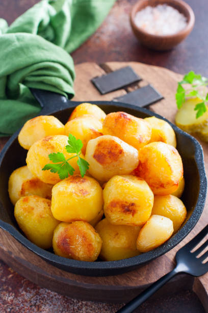 istock Whole potatoes fried in a pan, pushkin potatoes, selective focus 1279981141