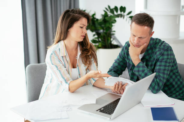 istock Husband and wife preparing bills to pay 1279981154
