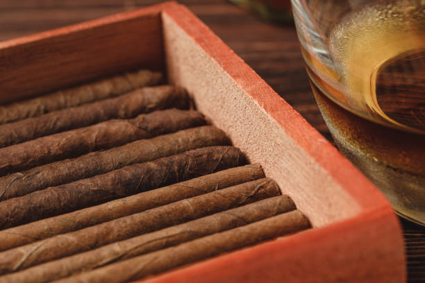 istock Red wooden box with rolled cigars on wooden table close up 1279981220