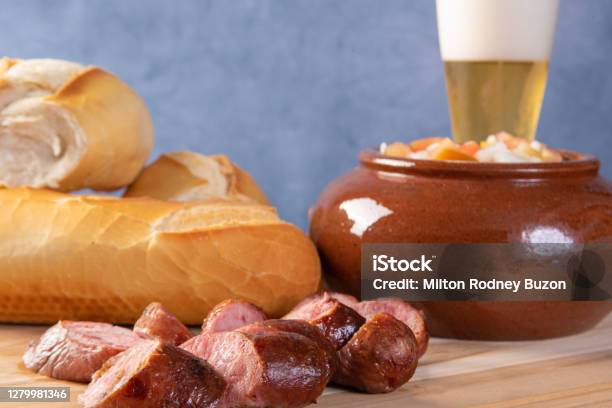 Breads Vinaigrette Sliced U200bu200broasted Sausage And A Glass Of Beer On A Table Blue Background Selective Focus Stock Photo - Download Image Now