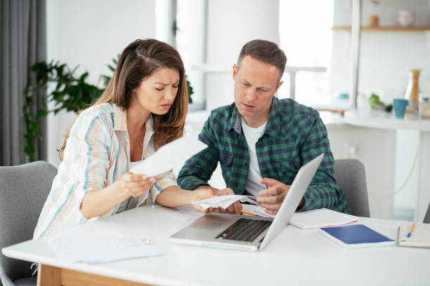 istock Husband and wife preparing bills to pay 1279981739