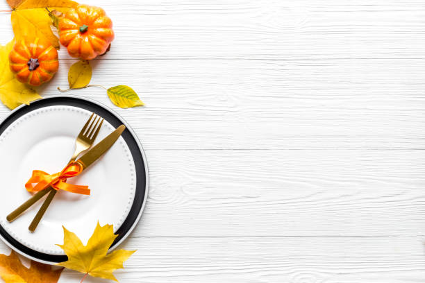 istock Thanksgiving day dinner table, top view . Autumn vegetables on plate with cutlery 1279982064
