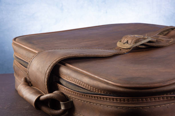 istock Details of an old suitcase, blue gradient background, selective focus. 1279983222