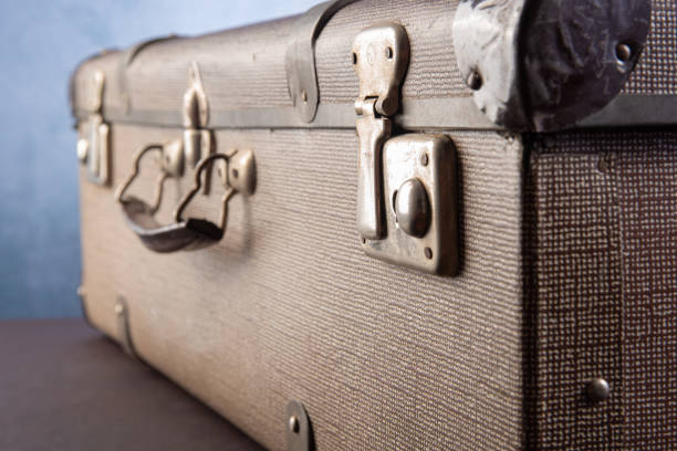 istock Details of an old suitcase, blue gradient background, selective focus. 1279983258