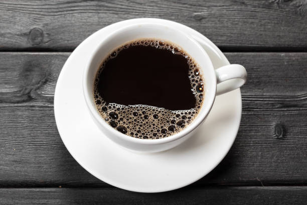 istock Top view of coffee cup on a wood background 1279983534