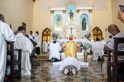 Quivican, May, CUB - August 08, 2020: A young seminarian prays at a religious celebration before being ordained a priest in the Archdiocese of Havana.  The mass is celebrated amid the outbreak of coronavirus cases in Havana.