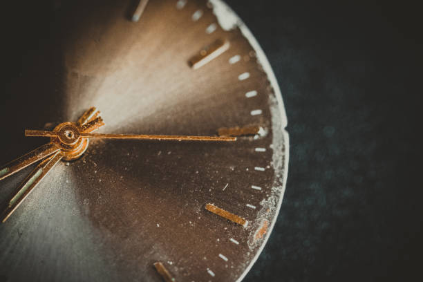 istock Vintage wall clock on a dark background. Selective focus. Vintage light toning. Grunge style backdrop 1279984759
