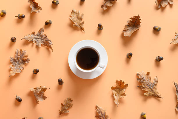 istock Acorn coffee with oak leaves on beige. View from above. 1279985457