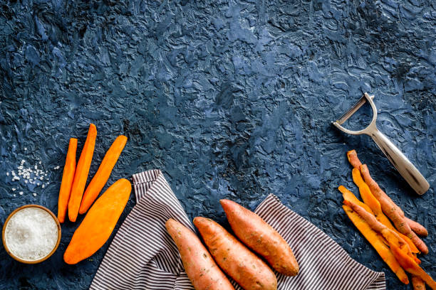 istock Raw orange sweet potato on cutting board, top view 1279985719