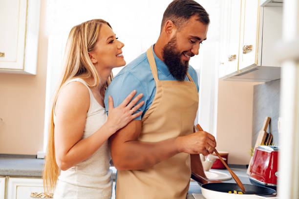 istock Young loving couple cooking together in kitchen 1279986790