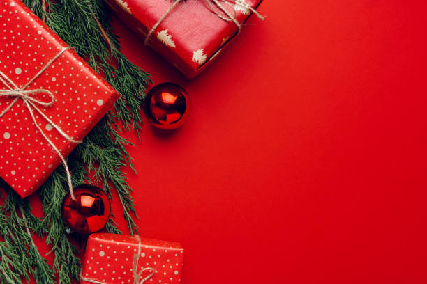 istock Red festive Christmas background with coniferous branches 1279986817