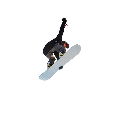 Isolated on white background girl snowboarder doing a jump trick on a snowboard.