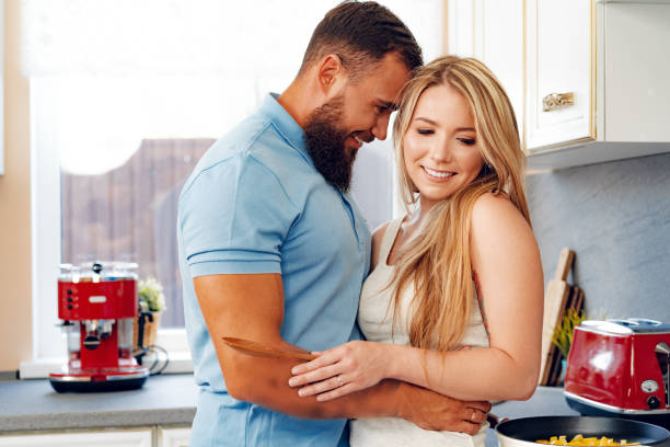 istock Young loving couple cooking together in kitchen 1279986976