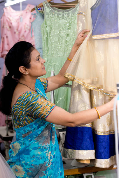 istock Indian woman holding thread spool at textile factory 1279987153