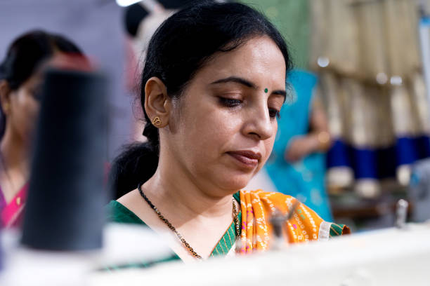 istock Indian woman textile worker on production line 1279987574