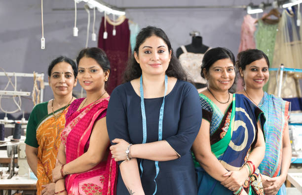 Female textile workers standing together in solidarity at factory Female textile workers standing together in solidarity at factory culture of india stock pictures, royalty-free photos & images