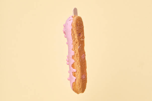 istock Vertically arranged Eclair in chocolate pink glaze. Rear view. 1279990137