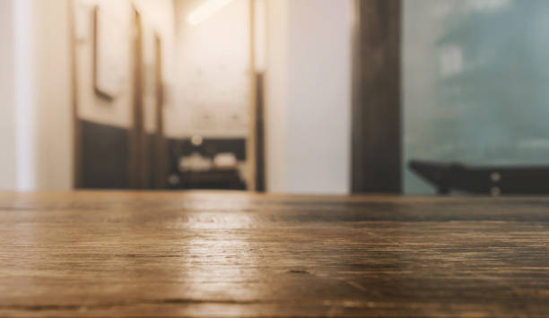 istock wooden table top with selective focusing and sunlight from window 1279990625