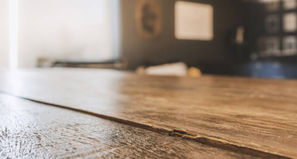 istock wooden table top with selective focusing and sunlight from window 1279990673