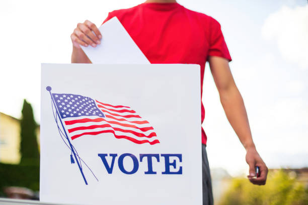 istock Man voting outside with face mask 1279991515