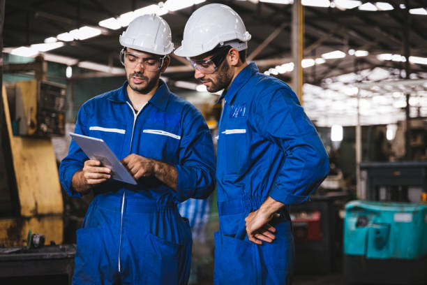 istock Industry maintenance engineer wearing uniform and safety helmet under inspection and checking production process on factory station by digital tablet. Industry, Engineer, construction concept. 1279992447