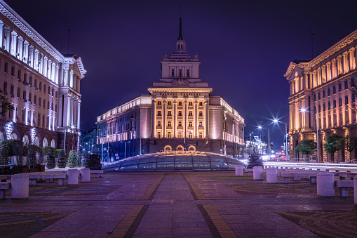 The Largo ensemble: National Assembly and blurred traffic light trails at night – Sofia, Bulgaria