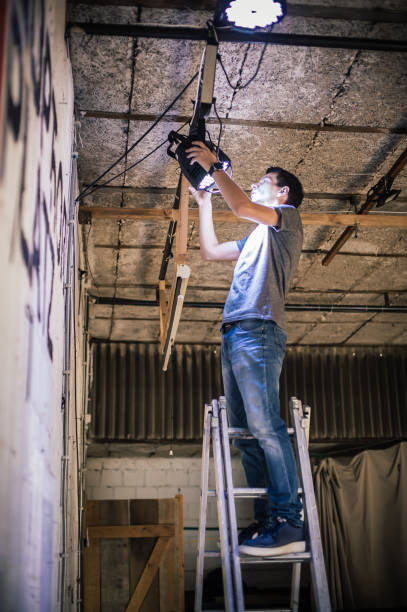 behind the scene. lighting technician electric engineer adjusting stage lights - ropes backstage theater imagens e fotografias de stock