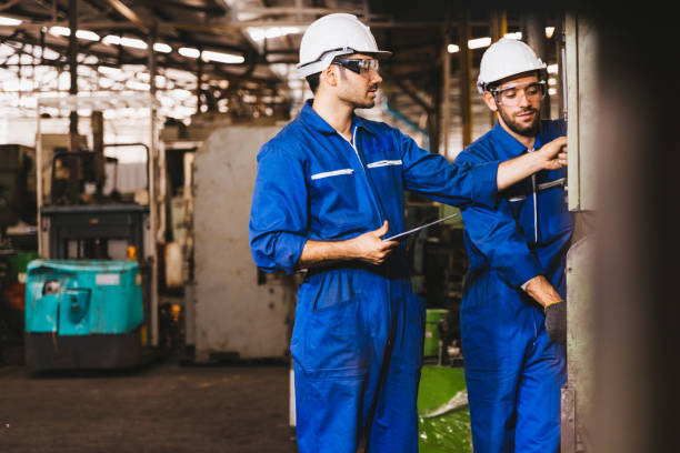 istock Industry maintenance engineer wearing uniform and safety helmet under inspection and checking production process on factory station by digital tablet. Industry, Engineer, construction concept. 1279992801