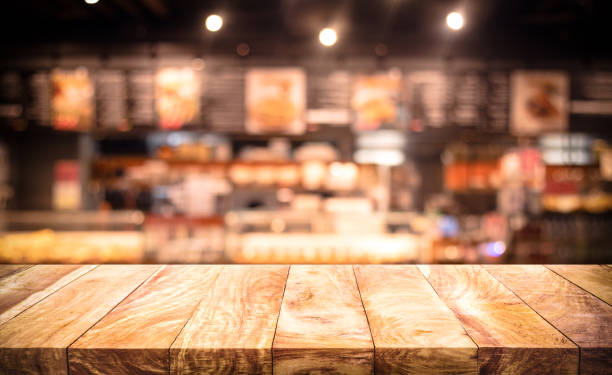 istock Wood table top (bar) with blur light bokeh in dark night cafe,restaurant background. 1279993375
