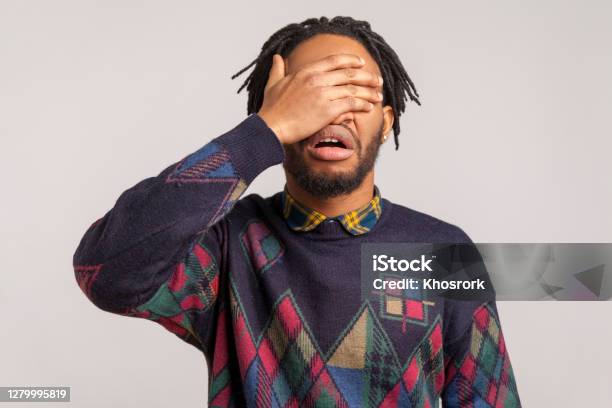 Angry Shocked African Guy With Beard And Dreadlocks Closing Eyes With Hand Hiding Dont Want To See And Know Ignorance Stock Photo - Download Image Now