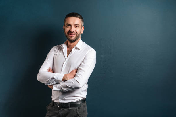 istock Handsome cheerful man standing over dark blue background 1279995908