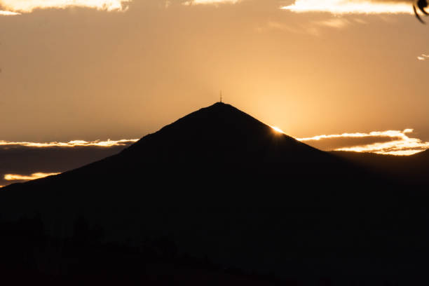 istock Mysterious sunset in the clouds over a hazy field and mountains. Sunset scenery 1279996785